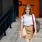 A teenage girl with a book and a backpack goes down the stairs and goes to school. Education, training, back to school. Space for text.